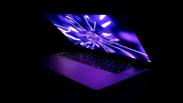 Open laptop with a glowing screen in a dark room