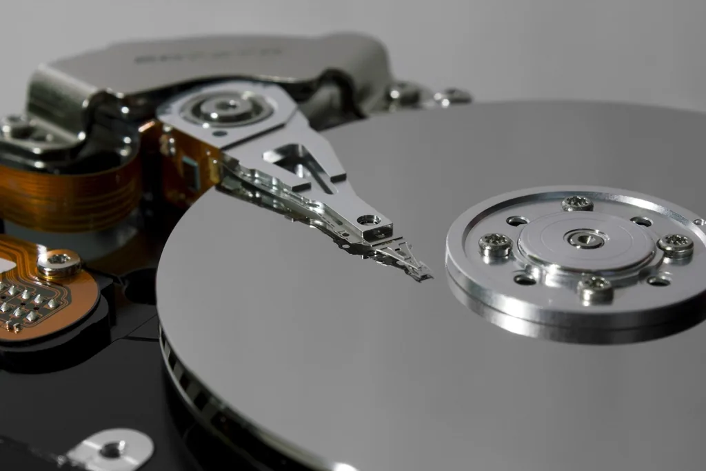 The platter and read head inside an opened hard disk drive